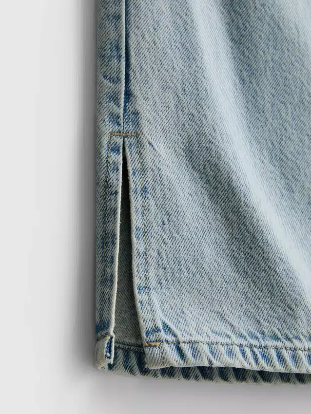 7–15 år | Jeans med splitt i buksebenet og vide ben