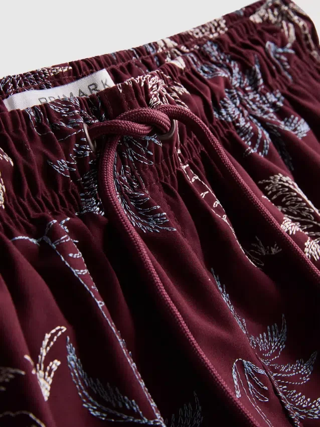 Badeshorts med brodert palmetre