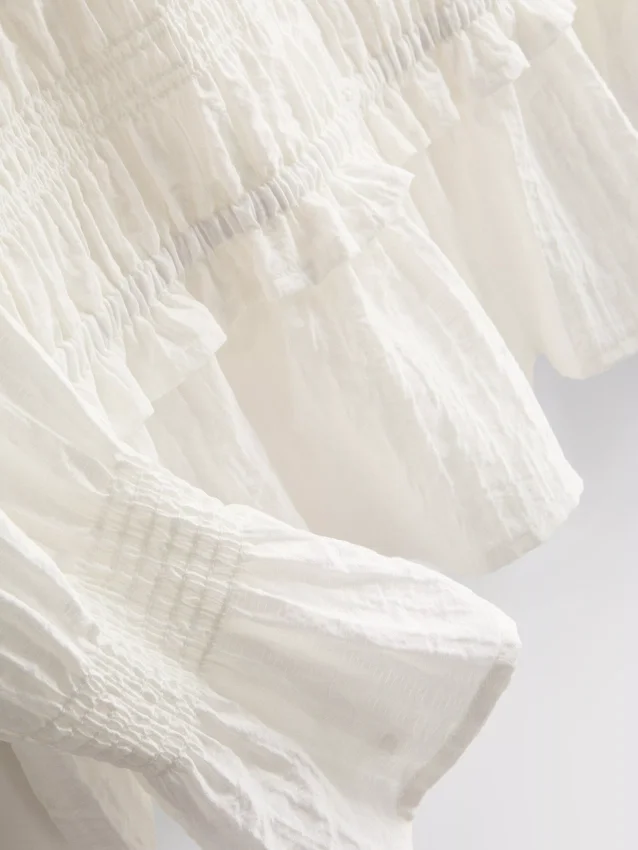 Bluse med rynket peplum-kant