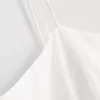 Cami-top i bomull med brodert peplum-kant