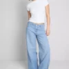 Jeans i bomullsdenim med middels høy midje og vide ben