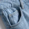 Jeans i bomullsdenim med middels høy midje og vide ben