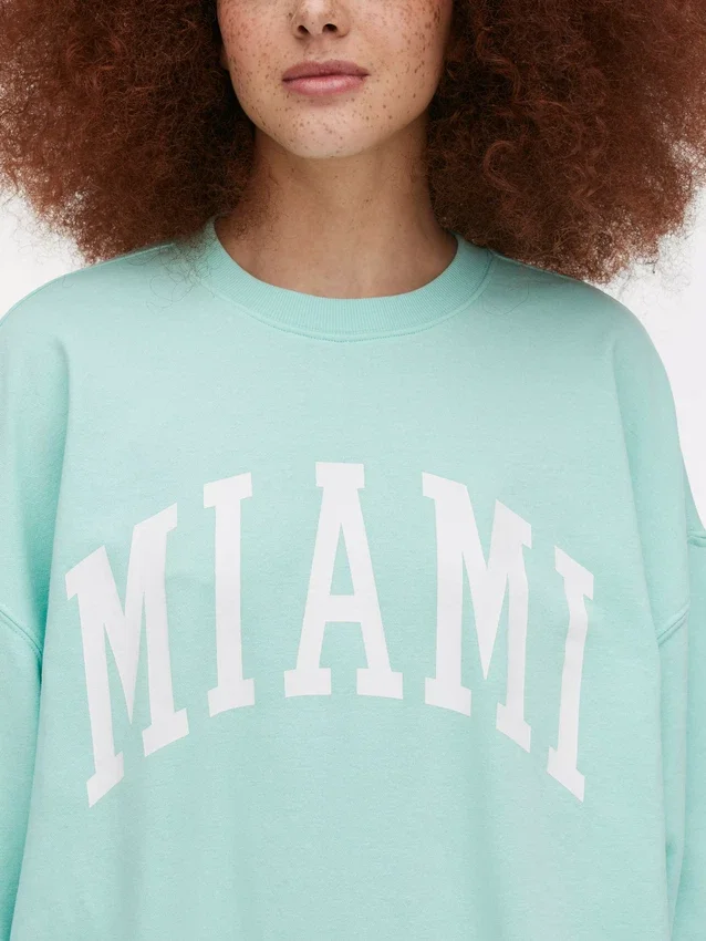 Oversized genser med «Miami»-skrift