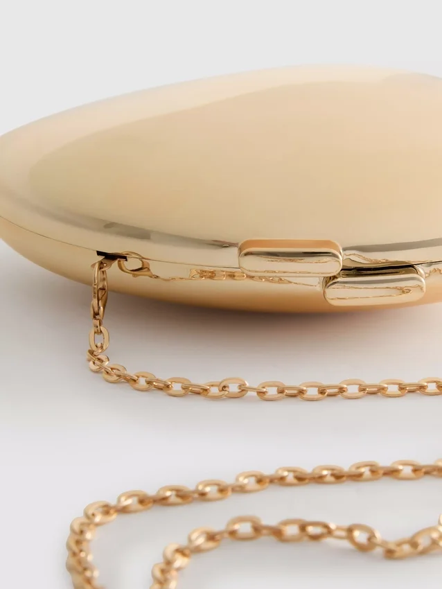 Paula Echevarría metallisk oval crossbody-veske