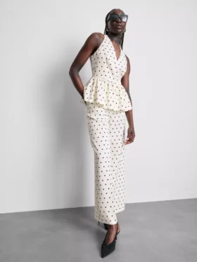 Peplum-top med halterneck og prikkemønster