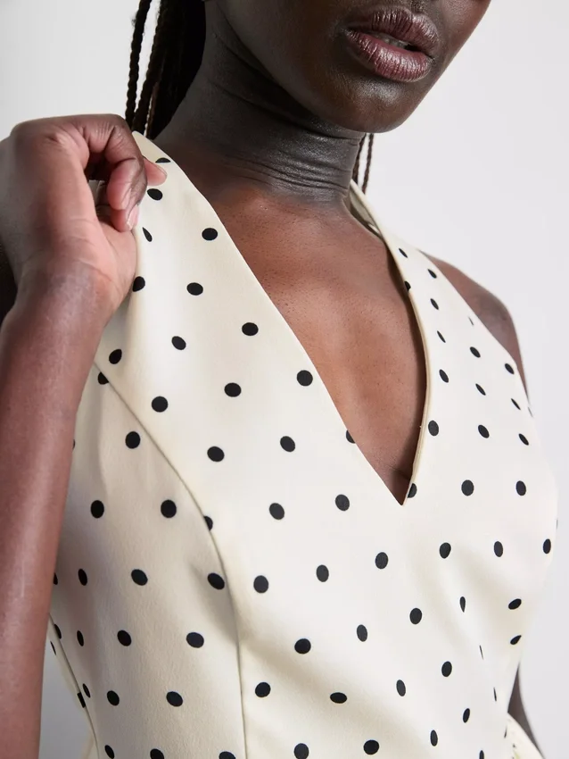 Peplum-top med halterneck og prikkemønster