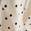 Peplum-top med halterneck og prikkemønster