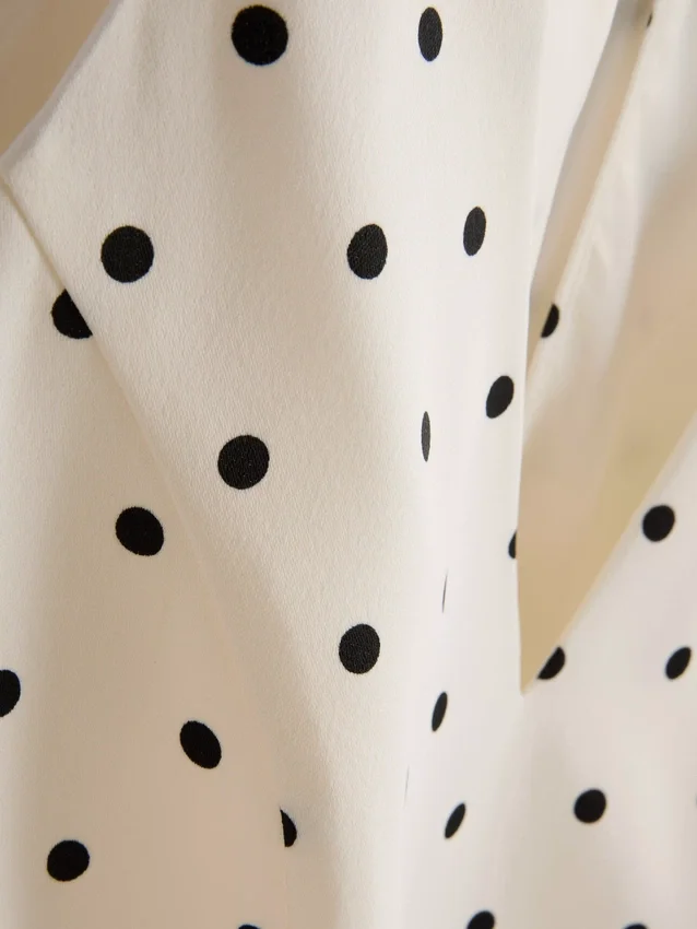 Peplum-top med halterneck og prikkemønster