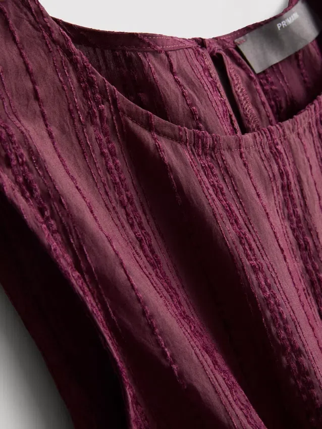 Stripet topp med peplum-kant