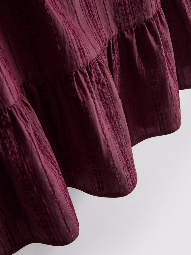 Stripet topp med peplum-kant