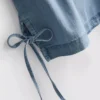 Tanktop i bomullsdenim med bånd i sidene
