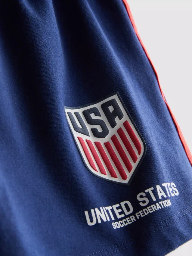 USA fotball-pysjamaser med korte shorts